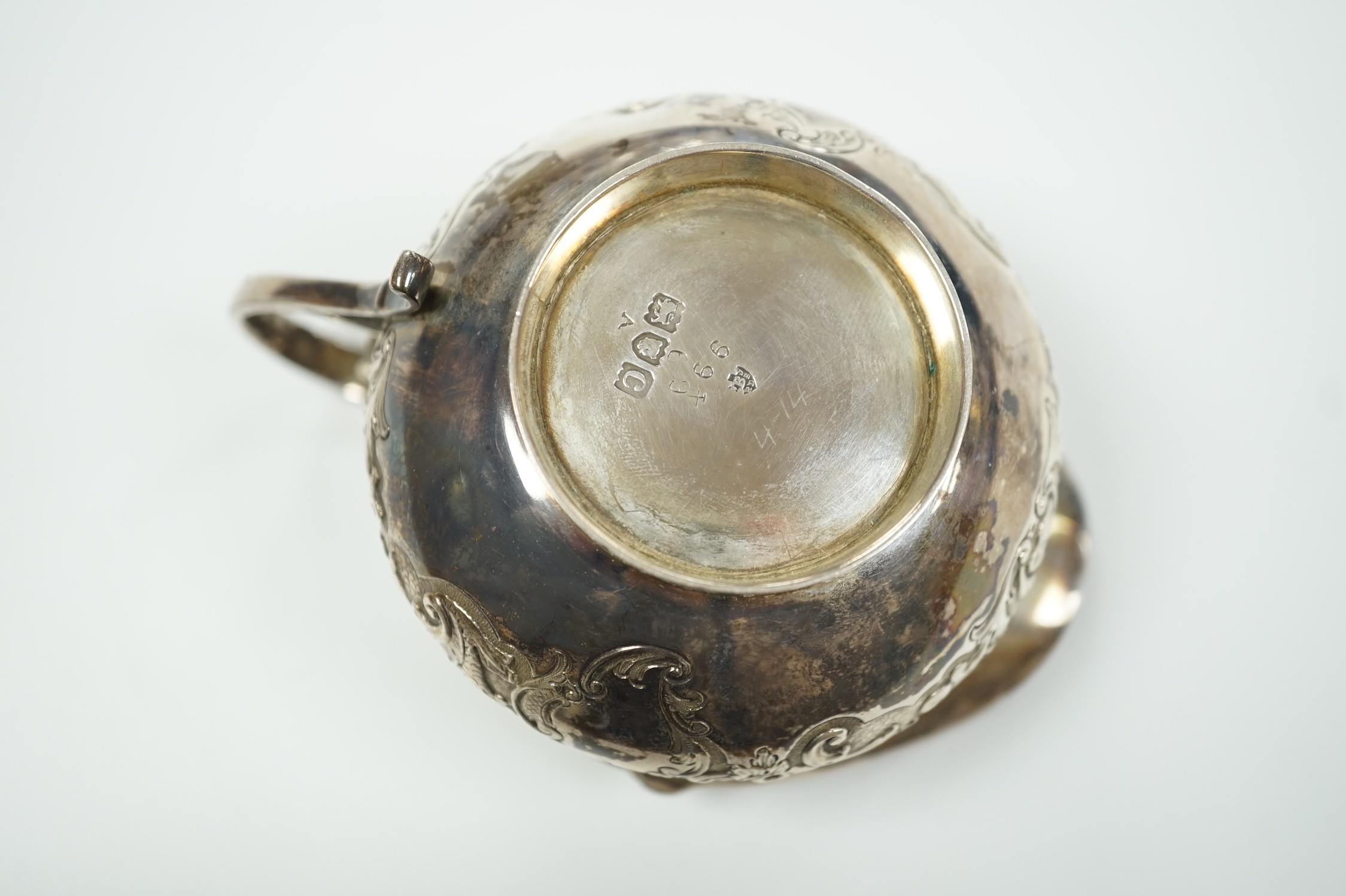 A late Victorian embossed squat silver cream jug, Edward Barnard & Sons, London, 1898, height 74mm, 4.6oz.